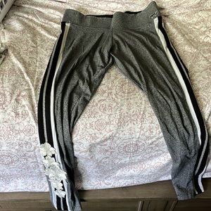 Pink yoga leggings with flower embroidery on one ankle